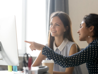 Two women looking at computer